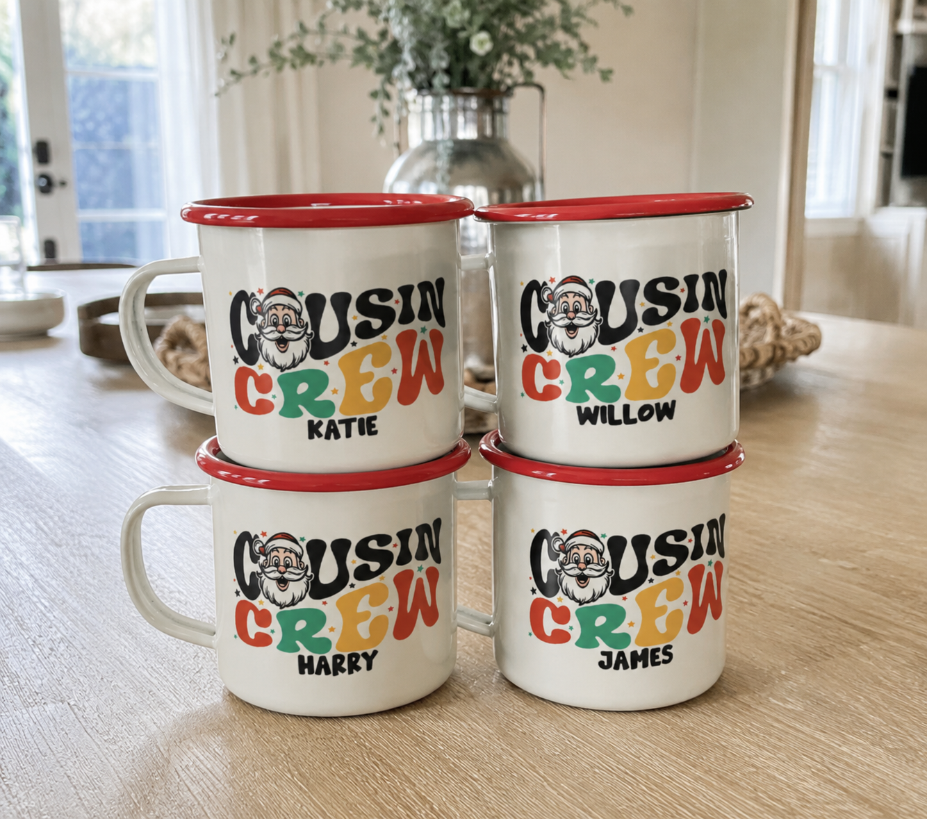 Four matching Santa Cousin Crew enamel mugs with red rims, a different cousin's name on each