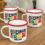 Three personalised Santa Cousin Crew enamel mugs on a wooden bench, retro Santa print detail - The Custom Co
