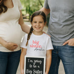 White Big Sister T-Shirt on hanger – custom kids' clothing for pregnancy announcements and big sister gifts