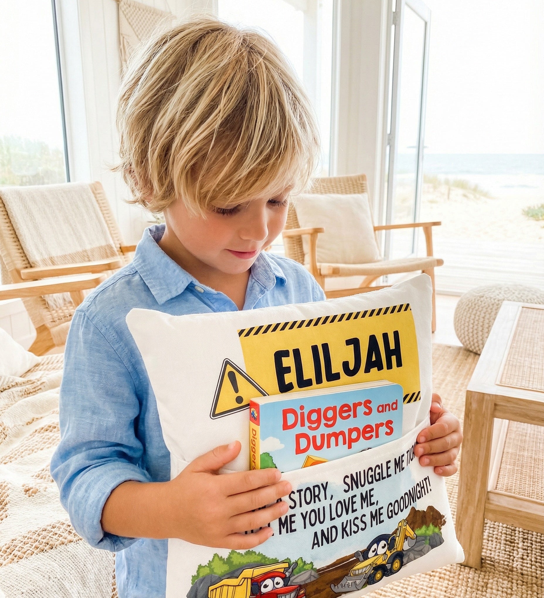 Personalised construction pocket book cushion with trucks and excavators for boys, featuring a built-in book pocket and custom name.
