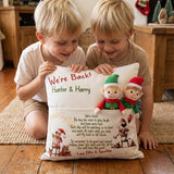 Customised "We’re Back" Christmas pillow with front elf pocket and child's name on rustic linen-style cushion cover