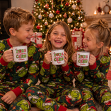 Three kids in Grinch pyjamas holding matching personalised Christmas Crew enamel mugs by the tree - The Custom Co