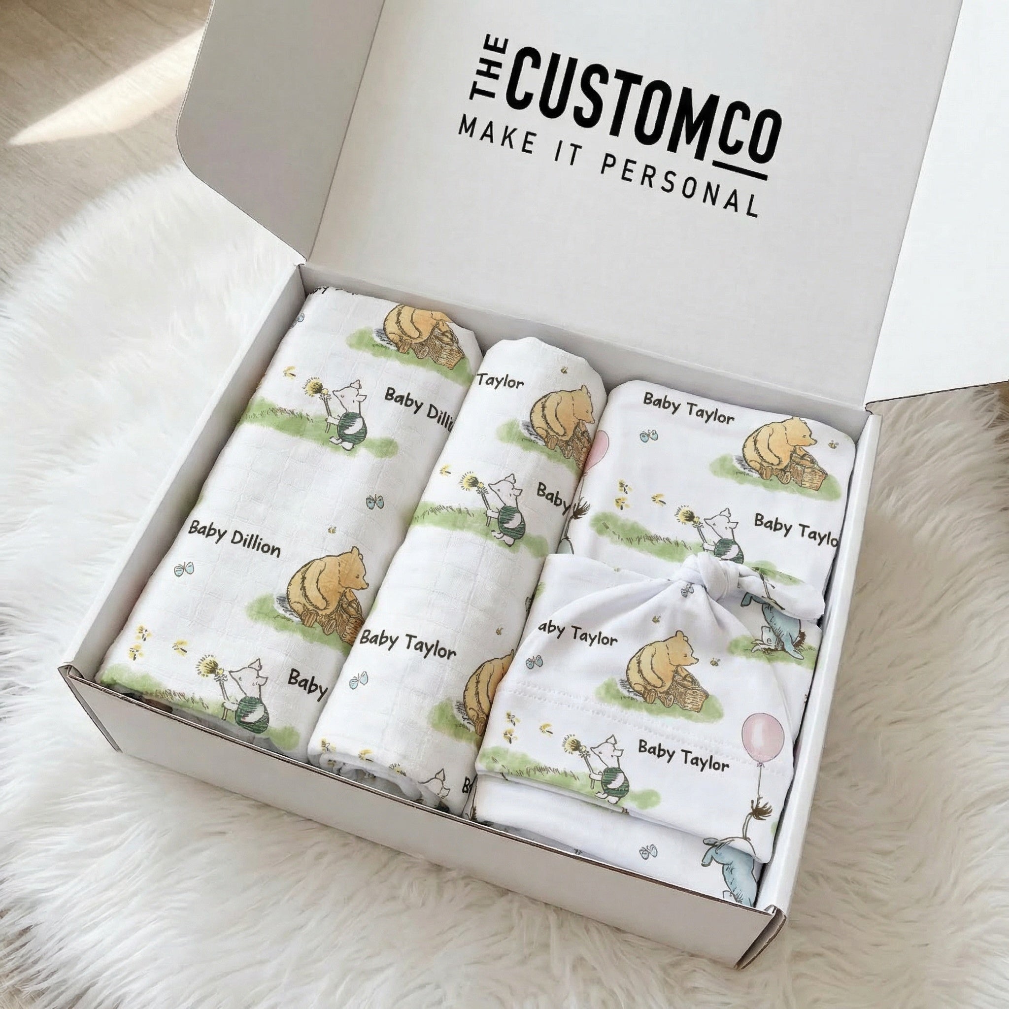 Personalised newborn essentials gift bundle with minky blanket, jersey swaddle, beanie, muslin swaddle, and 6-in-1 nursing cover baby box