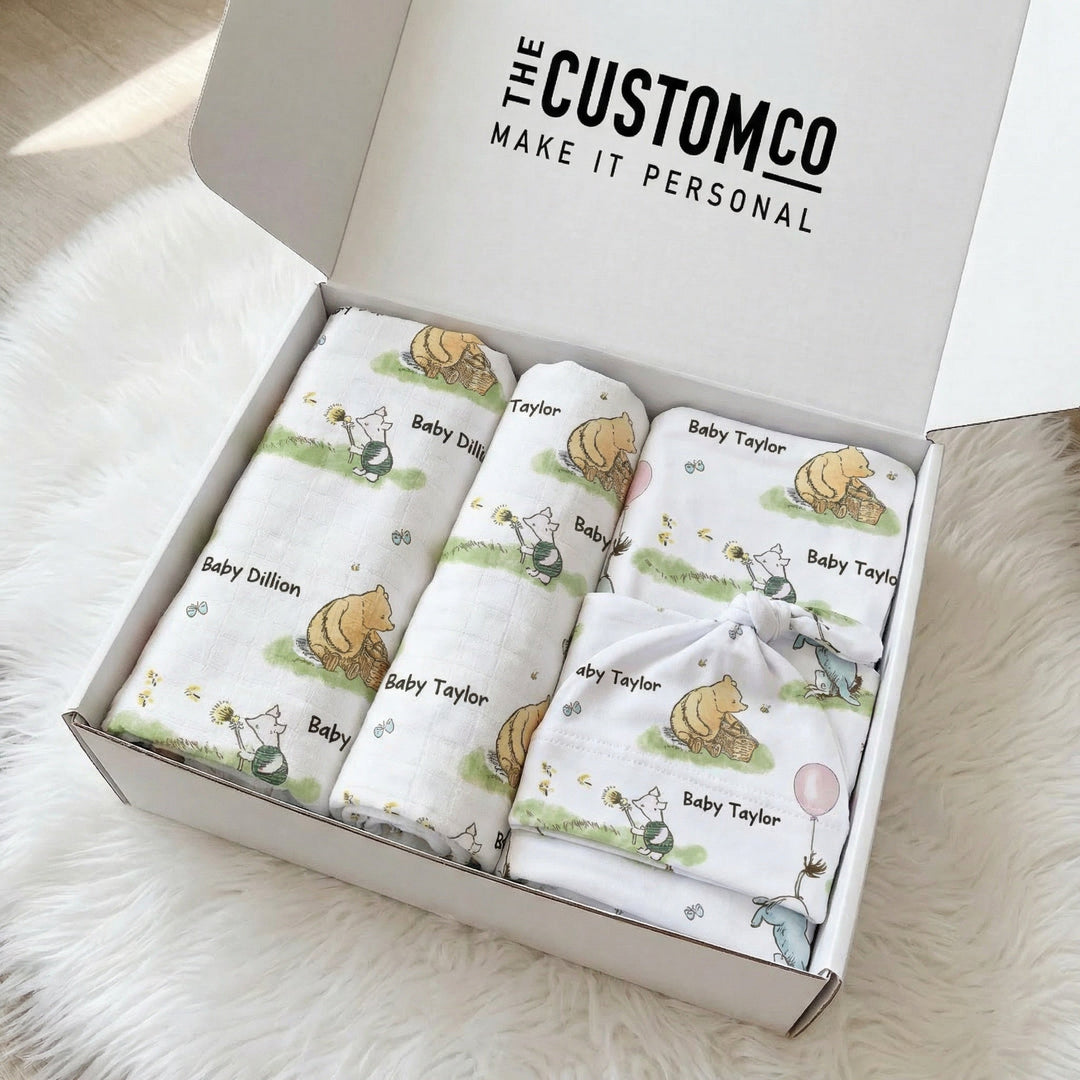 Personalised newborn essentials gift bundle with minky blanket, jersey swaddle, beanie, muslin swaddle, and 6-in-1 nursing cover baby box