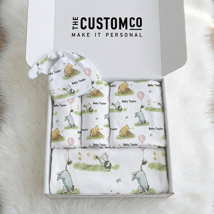 Personalised newborn essentials gift bundle with minky blanket, jersey swaddle, beanie, muslin swaddle, and 6-in-1 nursing cover baby box